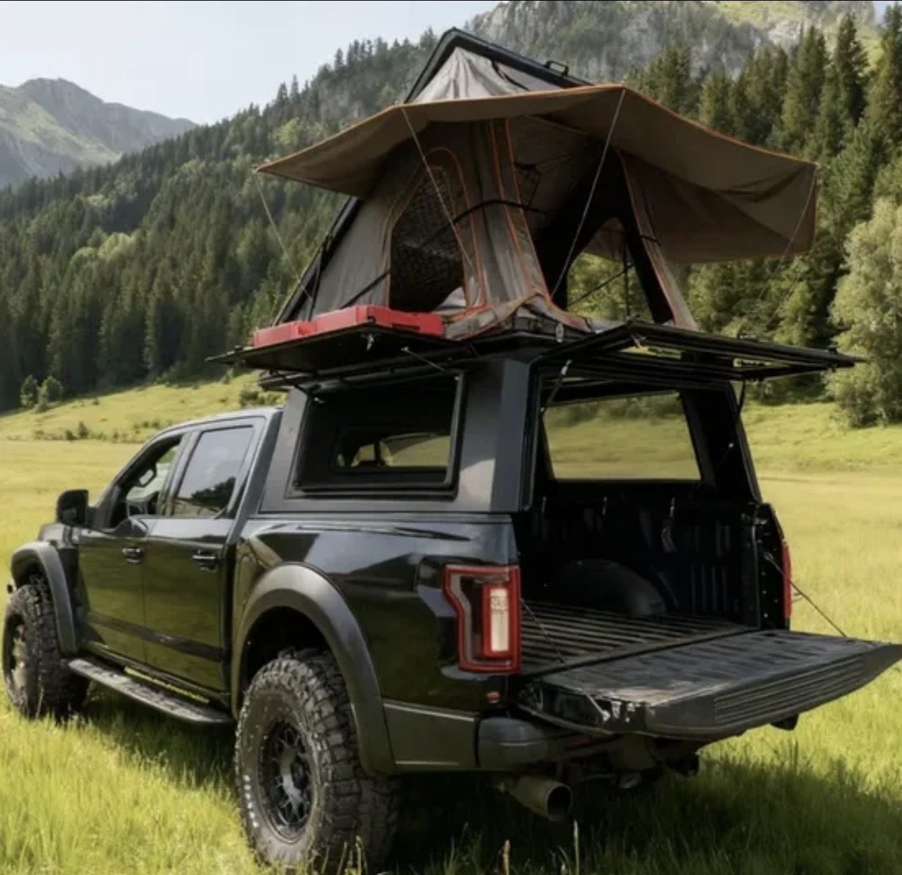 Black pickup camper in mountain area